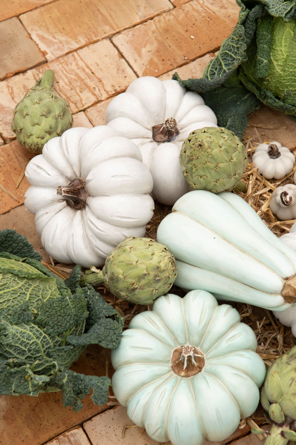 Vita och pastellgröna dekorativa pumpor med grönsaker på tegelunderlag | A Lot Decoration | Lilla Hem