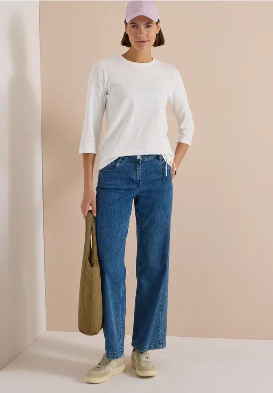 Modell bär vit trekvartsärmad tröja med blå jeans sett framifrån | Cecil | Lilla Hem