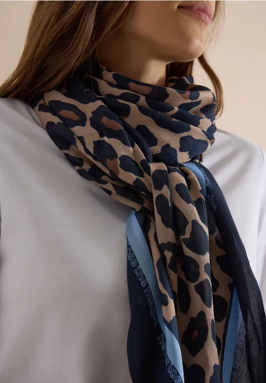 Närbild av scarf med leopardmönster i beige och marinblått, drapat runt halsen | Cecil | Lilla Hem