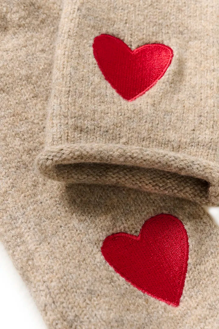 Beige stickade vantar med röda hjärtmotiv, detalj av handskarna vikt tillsammans | CULTURE | Lilla Hem
