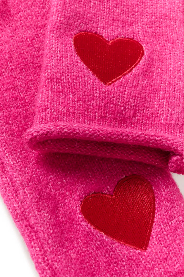Närbild av rosa vantar med röda sammetshärtformade detaljer | CULTURE | Lilla Hem