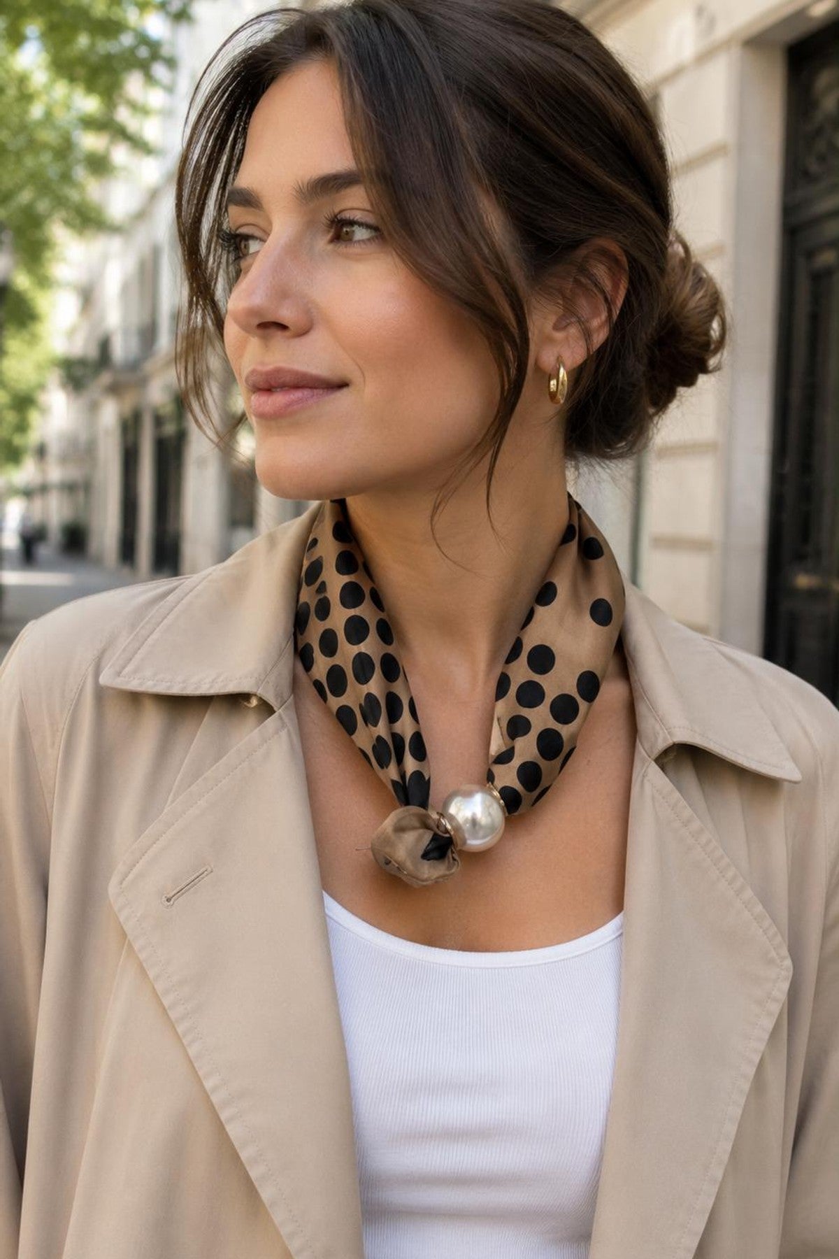 Modell bär beige scarf med svart prickigt mönster och pärldetalj, knuten runt halsen | BEST ANGEL | Lilla Hem