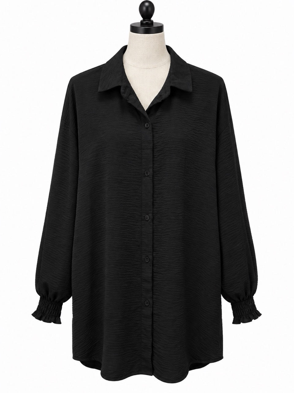 Svart tunika på skräddardocka, framifrån, med knäppning, bred krage och smockade manchetter | Caramelle Fashion | Lilla Hem